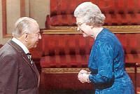 H.M. The Queen awarding the OBE to Lt. Col. Gray
